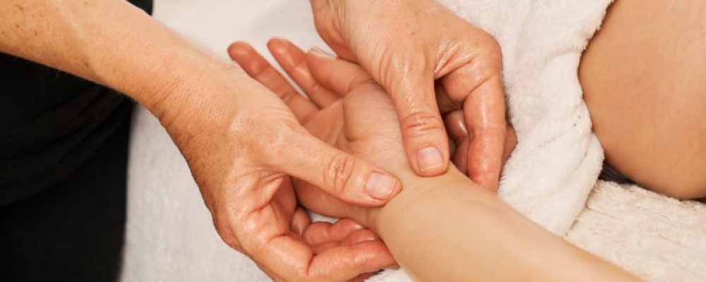 therapist-massaging-a-woman-s-hands-decontracting-2023-02-22-19-26-59-utc